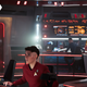 Pike stands in fronr of the Enterprise captain's chair as La'an and Ortegas pilot the ship.